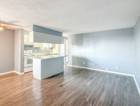 A kitchen with a white island in the middle of the room.